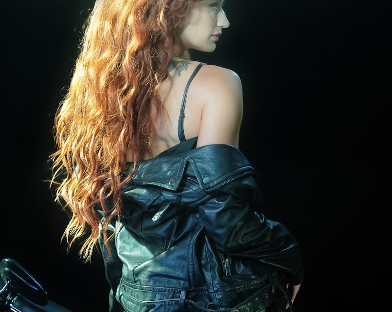 a woman wearing a black leather jacket